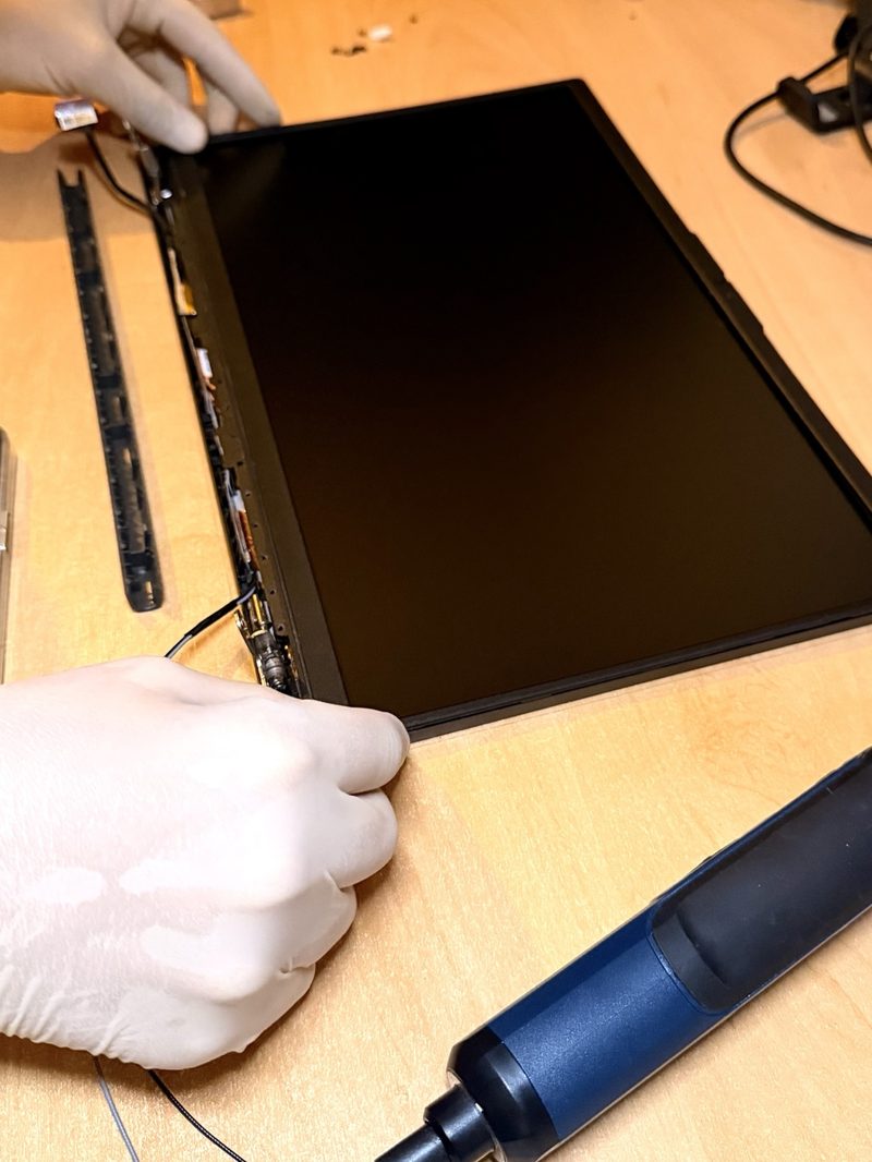 Remplacement de dalle d'écran sur un ordinateur portable, câble nappe débranché avec précaution
